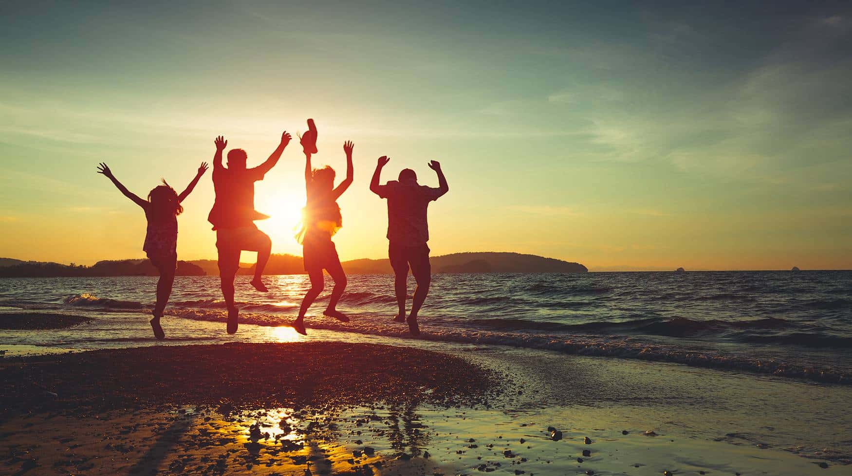 Hotel Employee Rate | Friend and Family on the Beach at sunset jumping
