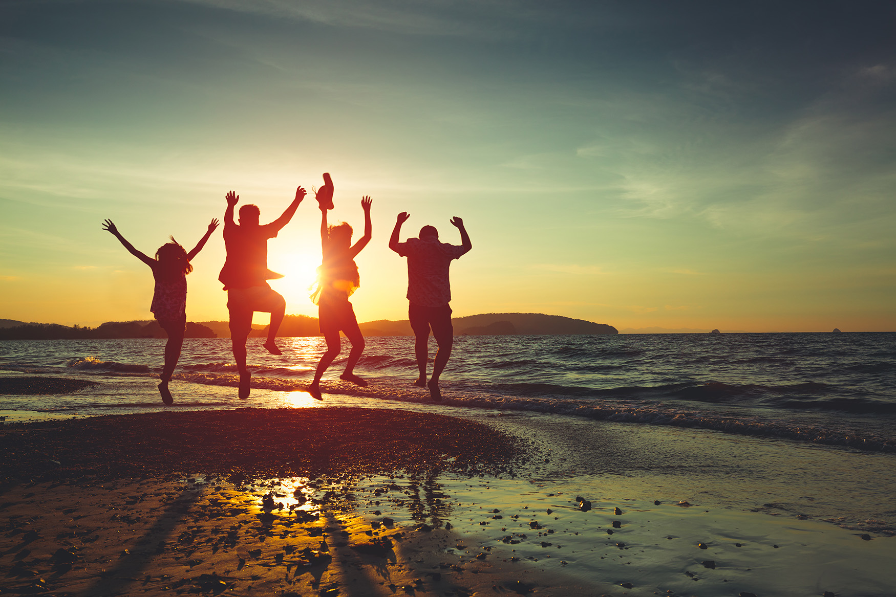 Hotel Employee Rate | Friend and Family on the Beach at sunset jumping