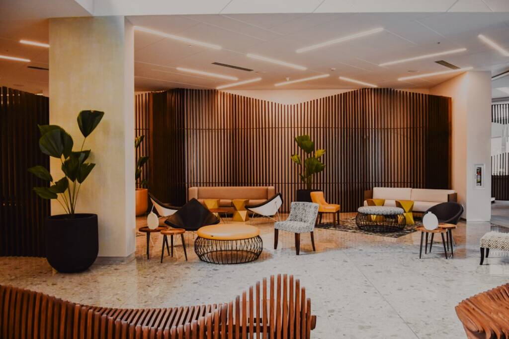 A modern hotel lobby with wood-paneled walls and comfortable seating.