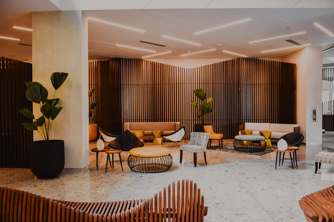 A modern hotel lobby with wood-paneled walls and comfortable seating.